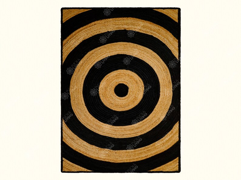 May include: A black and brown jute rug with a concentric circle pattern. The rug has a natural, earthy feel and would add a touch of texture to any room.