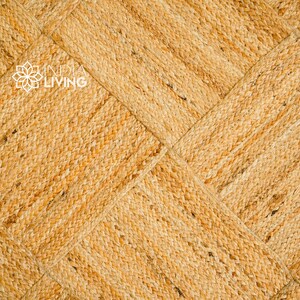 May include: A close-up of a natural fiber woven rug with a diamond pattern. The rug is a light brown color and has a textured surface.