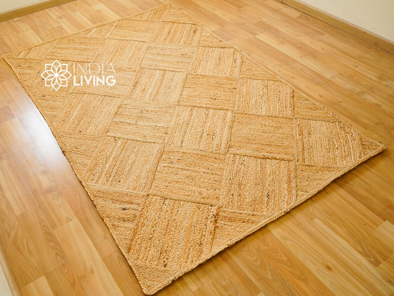 May include: A natural fiber rug with a woven diamond pattern. The rug is made of jute and has a light brown color.