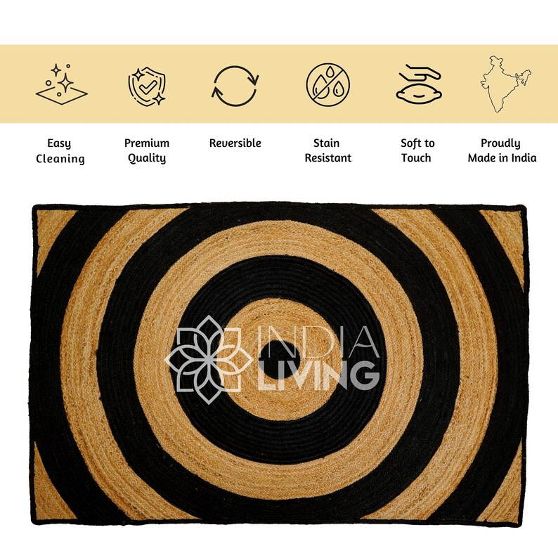 May include: A black and natural jute rug with a concentric circle pattern. The rug has the text "INDIA LIVING" in the center.