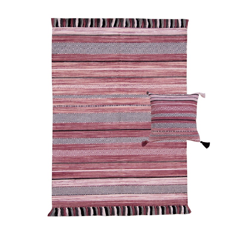 May include: A woven rug and matching pillow set in shades of pink, gray, and white. The rug features horizontal stripes and geometric patterns, with fringe detailing on the edges. The pillow has a similar striped design and tassels.