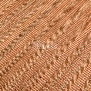 May include: A woven area rug featuring a dense, textured herringbone pattern in alternating shades of warm tan, light brown, and dark brown fibers. The surface displays a consistent, repeating V-shaped weave structure throughout the entire visible area.
