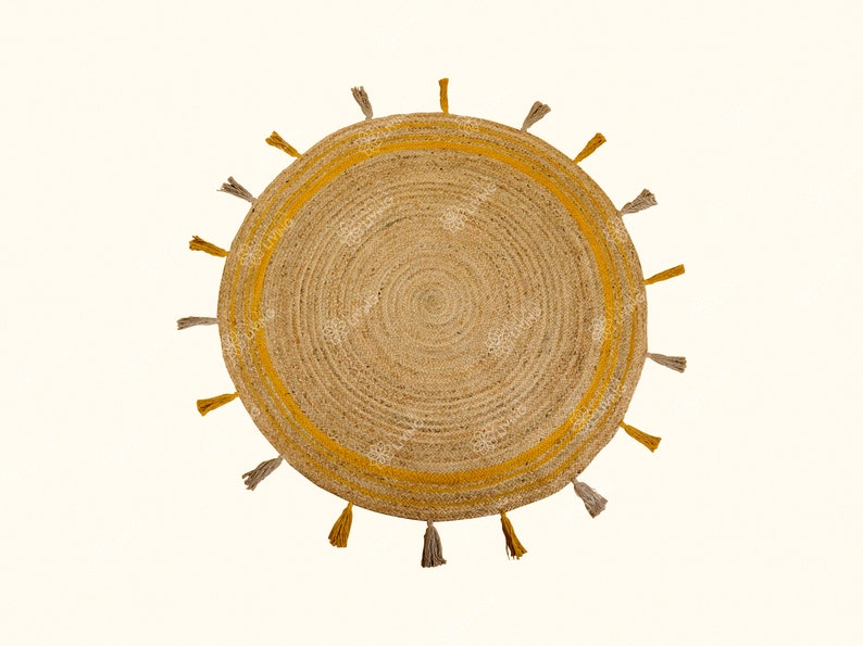 May include: Round jute rug with a yellow border and tassels. The rug has a natural, woven texture.