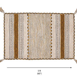May include: A rectangular woven rug featuring a central panel of textured beige and grey fibers flanked by vertical stripes of mustard yellow, black, and white geometric patterns. The rug measures 3 feet by 5 feet and includes decorative tassels at each corner.