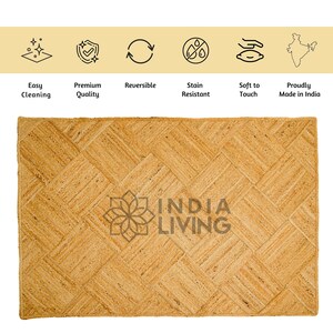 May include: A natural fiber rug with a woven chevron pattern in a light brown color. The rug has the text "INDIA LIVING" printed in the center.