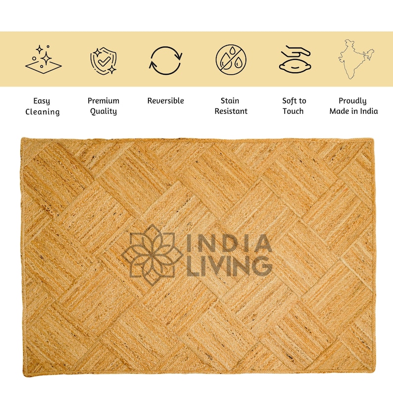 May include: A natural fiber rug with a woven chevron pattern in a light brown color. The rug has the text "INDIA LIVING" printed in the center.