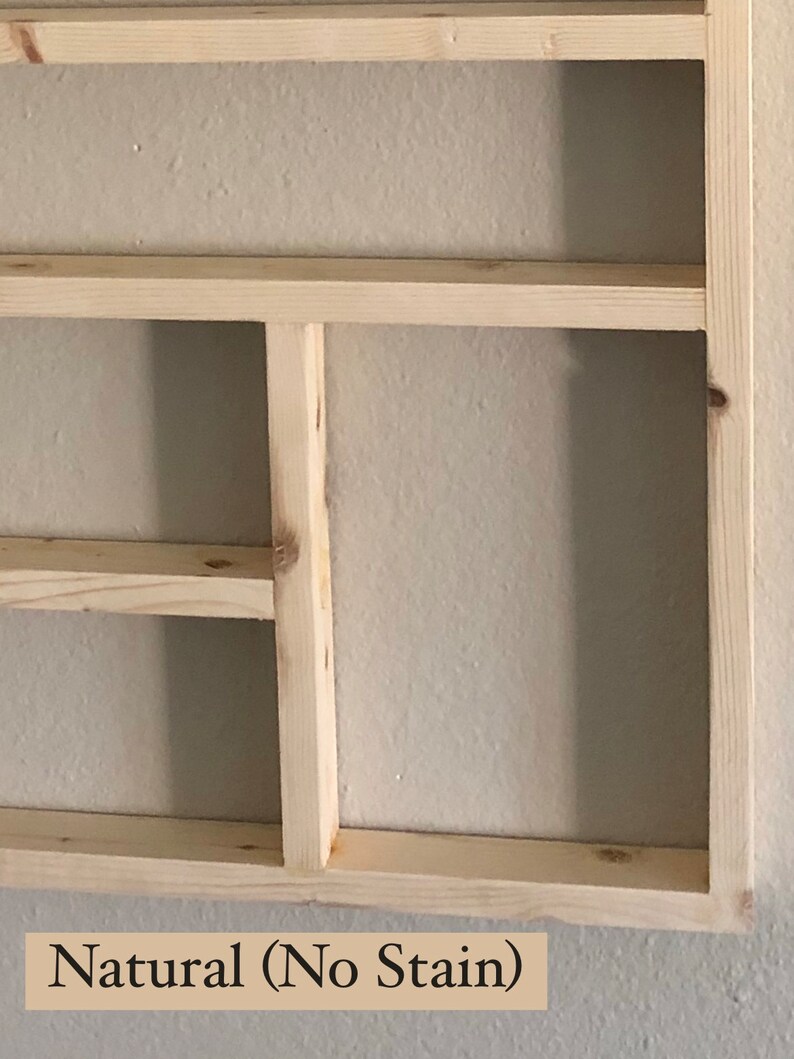May include: A natural wood shelf unit with three shelves. The shelves are unfinished and have a light wood color. The text "Natural (No Stain)" is printed below the shelves.