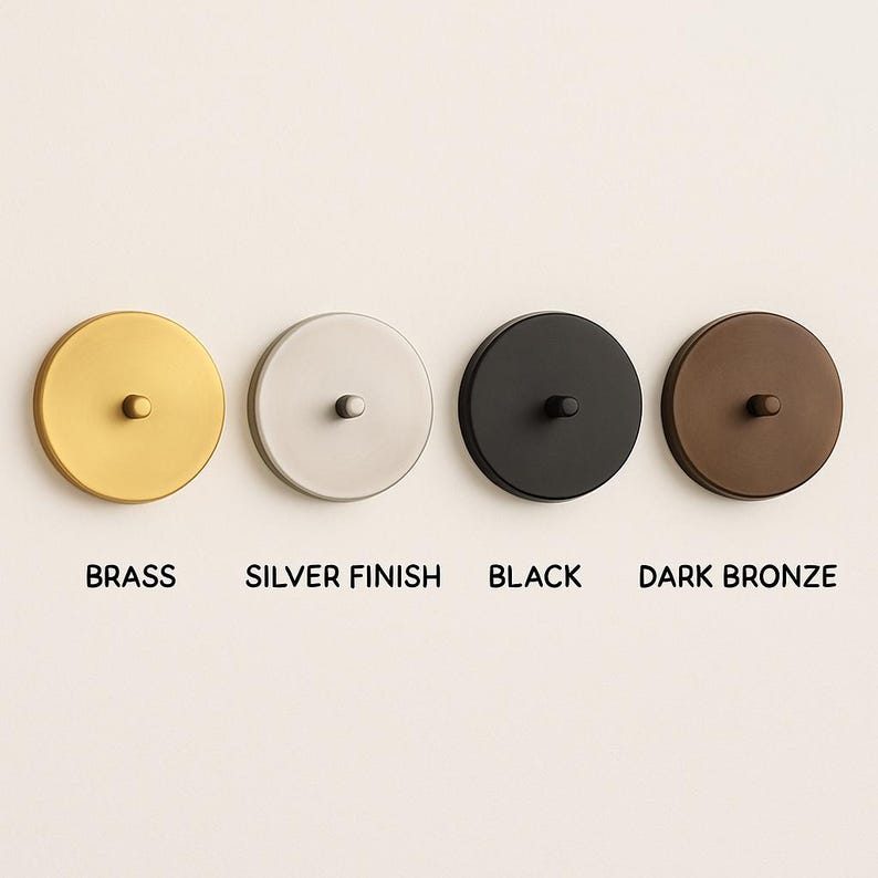 May include: Four round, metallic ceiling canopy covers in brass, silver finish, black, and dark bronze. Each has a small, central screw. The colors are labeled below each canopy.