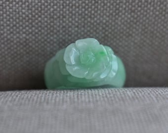 May include: A green jade ring carved in the shape of a rose.