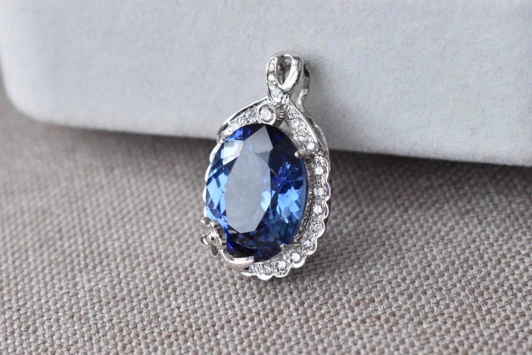 Lab-grown Blue Oval Ceylon Sapphire and Moissanite Halo Pendant in 10K ...