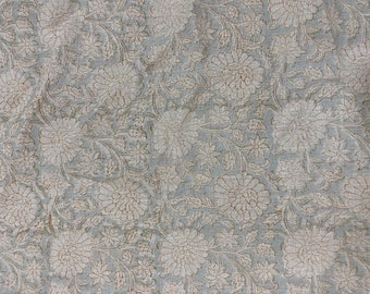 May include: A light blue fabric with a white floral pattern. The fabric has a subtle texture and a vintage look.