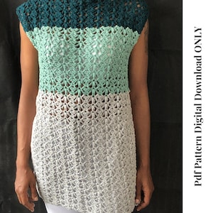 Könnte beinhalten: Ein Häkeltop mit einem Farbverlauf in Türkis, Mintgrün und Grau. Das Top hat eine lockere Passform und einen weiten Ausschnitt. Das Top ist mit einem einfachen Stichmuster gearbeitet und hat eine leicht strukturierte Optik.