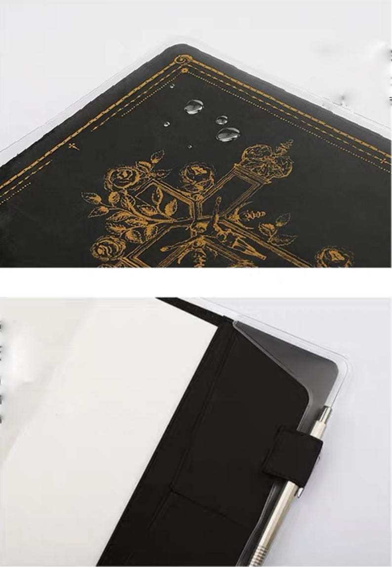 Puede incluir: Un diario de cuero negro con un dise&ntilde;o en relieve dorado de rosas y una cruz. El diario est&aacute; protegido por una cubierta de pl&aacute;stico transparente. El diario est&aacute; abierto para revelar p&aacute;ginas blancas en blanco.