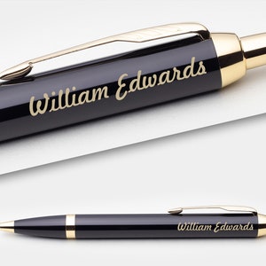 May include: A black and gold pen with the name "William Edwards" engraved on the side.