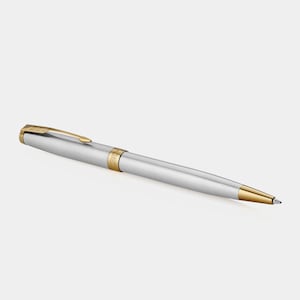 May include: A silver and gold ballpoint pen with a classic design.