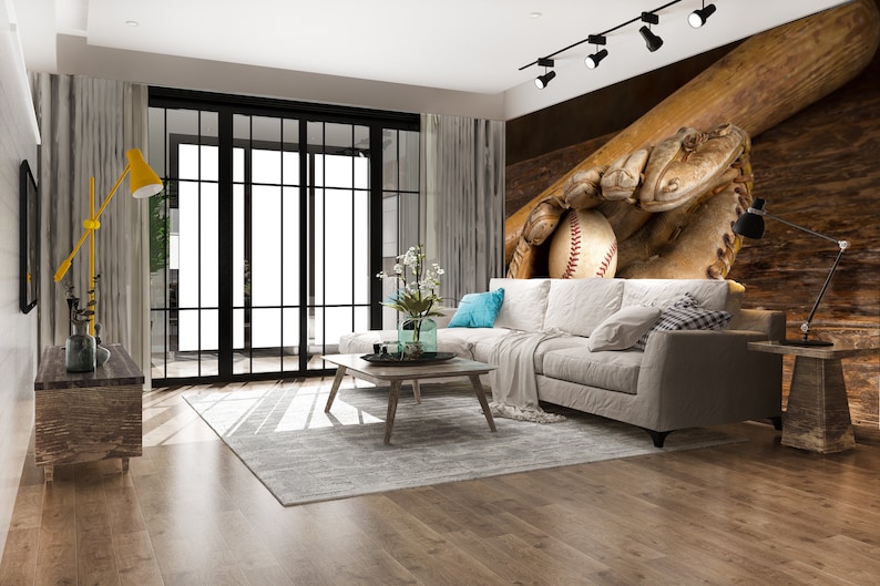 May include: A living room interior with a white sectional sofa, a wooden coffee table, and a rug. The wall behind the sofa features a mural of a baseball glove catching a ball with a bat behind it.