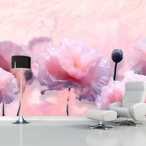 May include: A pink floral wallpaper featuring large pink flowers with a soft, watercolour effect. The wallpaper is complemented by a black floor lamp and a white armchair with an ottoman.