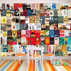 May include: A white wall with a colorful collage of book covers. The wall is decorated with a variety of books, including classics, contemporary fiction, and non-fiction. The books are arranged in a grid pattern, and the colors are bright and vibrant. There are three white chairs and a white table in front of the wall. The floor is covered in a striped rug with orange, blue, and white stripes. There are a few colorful wooden blocks on the floor.
