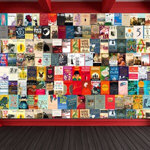 May include: A wall covered in book covers, featuring a variety of titles and authors. The wall is painted red and has a red trim. The floor is made of dark wood.