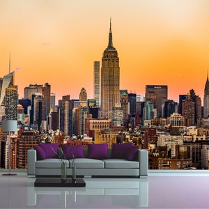 Puede incluir: Una vista panorámica del horizonte de la ciudad de Nueva York al atardecer, con el Empire State Building destacado en el centro de la imagen.