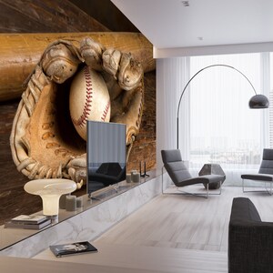 May include: A baseball mitt with a baseball inside, resting on a wooden surface with a baseball bat behind it. The mitt is brown leather with white stitching. The baseball is white with red stitching. The bat is brown wood.