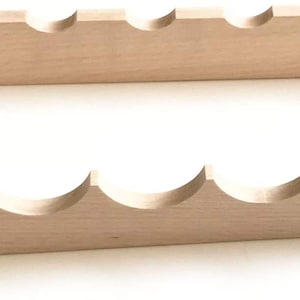 May include: Two wooden shelves with a scalloped edge design. Each shelf has a series of curved cutouts that create a decorative pattern.