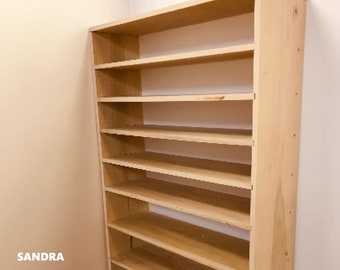 May include: A light wood bookshelf with seven shelves. The shelves are evenly spaced and the bookshelf is freestanding.