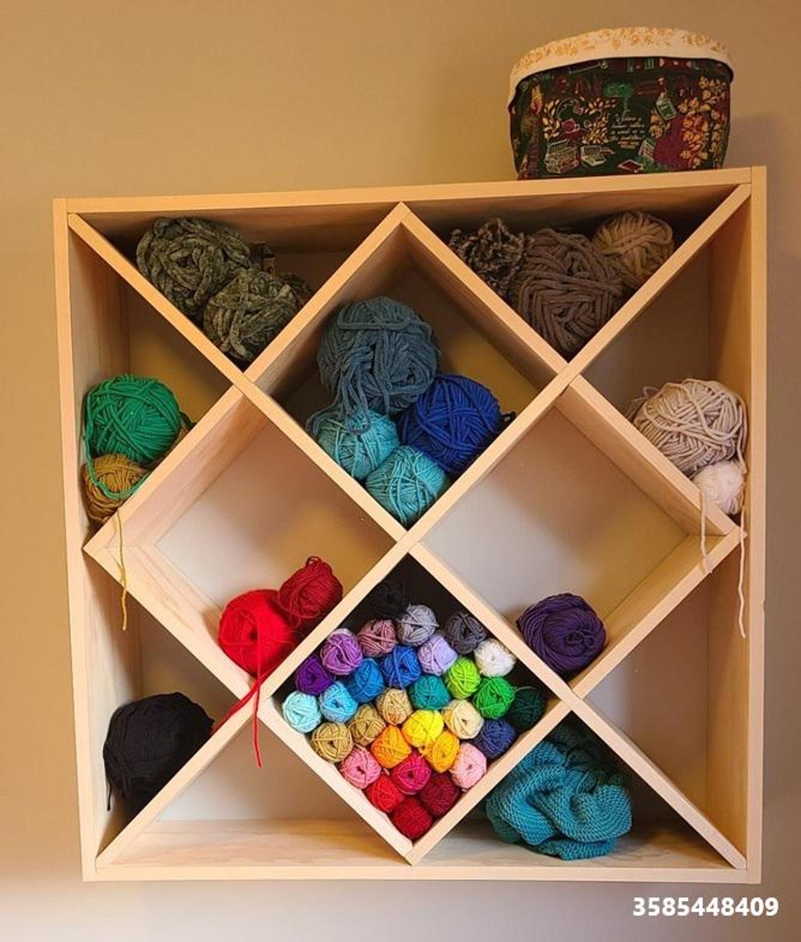 Modular yarn storage rack with diamond cubbies filled with colorful yarn