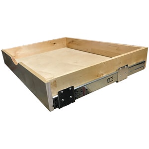May include: A wooden drawer box with a chrome drawer slide. The drawer box is made of unfinished wood and has a natural wood color. The drawer slide is attached to the bottom of the drawer box and is made of metal.