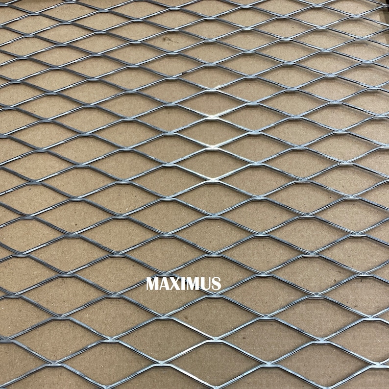 May include: A silver expanded metal sheet with a diamond pattern. The sheet has the word "MAXIMUS" printed on it.