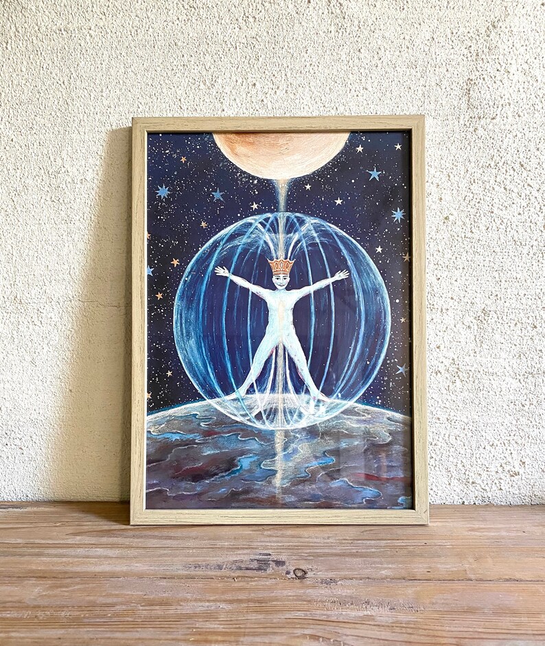 May include: A framed painting of a person in a crown standing in a sphere of light with their arms outstretched. The person is surrounded by stars and a moon. The painting is on a wooden surface.