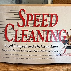 May include: A book cover with the title "SPEED CLEANING" in red letters on a white background. The book is by Jeff Campbell and The Clean Team. The subtitle is "The people who clean San Francisco homes 10,000 times a year!" and includes the text "Clean your home in half the time or less! Guaranteed." and "Cleaning for people who have much better things to do."