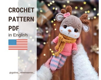 May include: Crochet pattern PDF in English for a brown and pink reindeer amigurumi toy with a yellow scarf. The pattern is available for download. @galina_veremeenko_