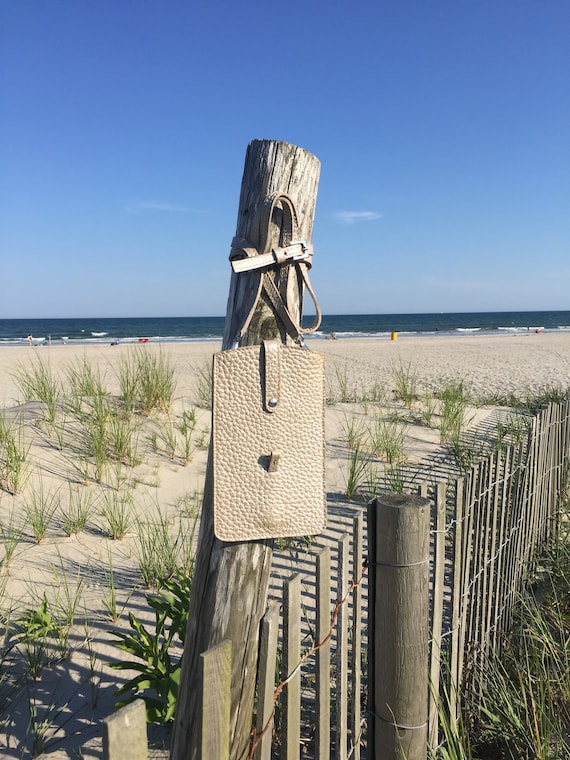 A cellphone leather bag with a leather or chain shoulder strap.