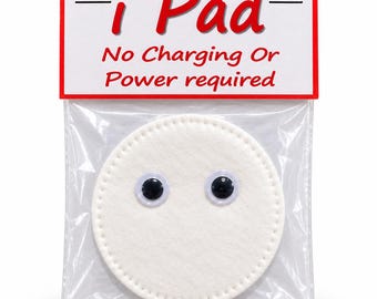 May include: A circular white felt pad with two attached plastic googly eyes, enclosed in a clear plastic bag with a white header card featuring red text that reads i Pad and No Charging Or Power required.