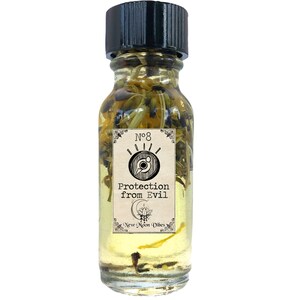May include: A clear glass bottle with a black cap, filled with yellow liquid and botanical elements. The label reads "No. 8 Protection from Evil" with a stylized eye symbol. The bottle is from "New Moon Vibes".