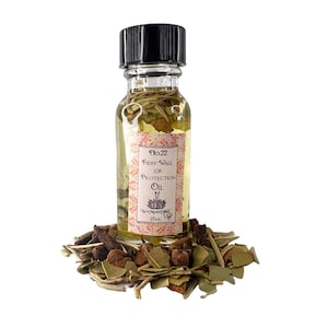 May include: A small glass bottle with a black cap filled with a yellow liquid. The bottle has a label that reads "No. 22 Fiery Wall of Protection Oil" and "New Moon Oils 15mL". The bottle is sitting on a pile of dried herbs.