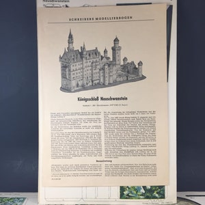 May include: A black and white illustration of Neuschwanstein Castle, a 19th-century Romanesque Revival palace in southwest Bavaria, Germany. The illustration is from a model kit by Schreibers Modellierbogen.
