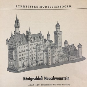 May include: A black and white illustration of Neuschwanstein Castle, a large, elaborate castle with many towers and spires. The text "K&ouml;nigsschlo&szlig; Neuschwanstein" is printed below the image. The text "Ma&szlig;stab 1:200 Bestellnummer JFS-7 853 (11 Bogen)" is printed below the castle.