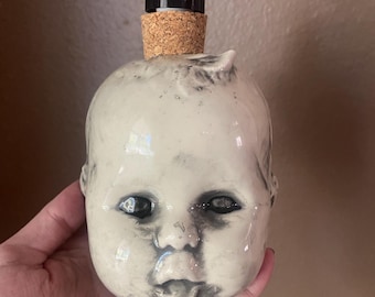 Spooky baby doll head soap dispenser
