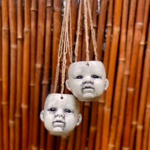 Hanging baby head planter.