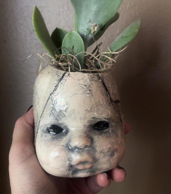 Zombie baby head planter