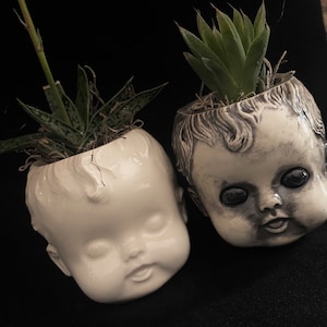 Small doll head planter.