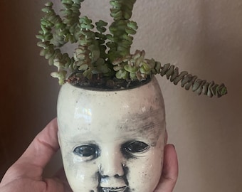 Small spooky baby head planter.