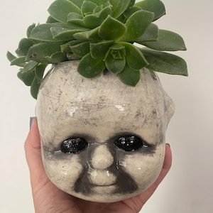 Creepy Kewpie head planter