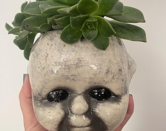 Creepy Kewpie head planter