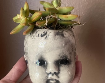 Small spooky baby head planter.