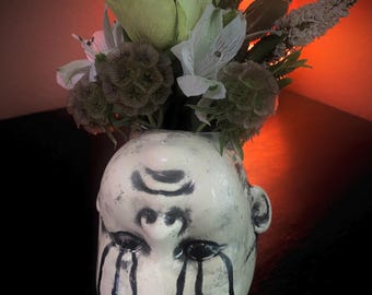 Creepy doll upside down flower  vase.