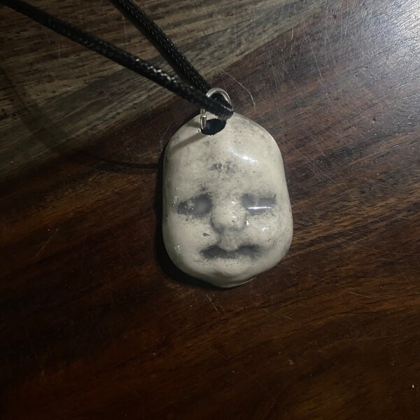 Haunted baby necklace