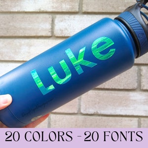 May include: A blue water bottle with a black lid and a green iridescent vinyl sticker that says "LUKE".